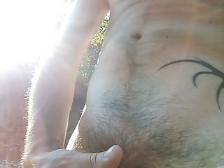 Unexpected seclusion in nature leads to naked man stroking in the sunshine