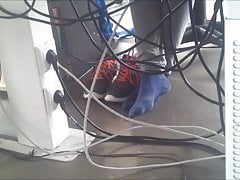 My sexy colleagues feet in socks dangling during work