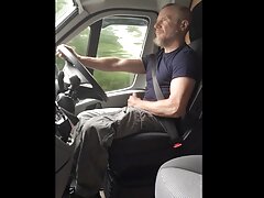 Muscular trucker jerks off and cums while driving