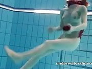Redhead Mia stripping underwater