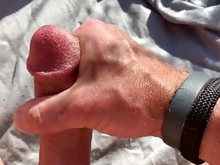 Stroking my hard cock in the field, stay tuned for more!