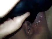 Black toy in creamy pussy