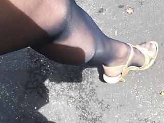 In off black pantyhose and heels