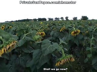 Real passion of teenage couple in the field of sunflowers