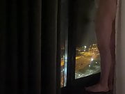 Naked standing hotel window 