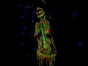 Glowing paint at night on a naked body.