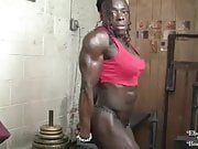 Black female bodybuilder poses and flexes