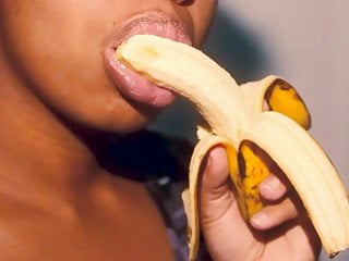 Naughty ebony with sexy lips playing with a banana