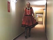 Sissy Ray in Red Sissy Dress in hotel hallway